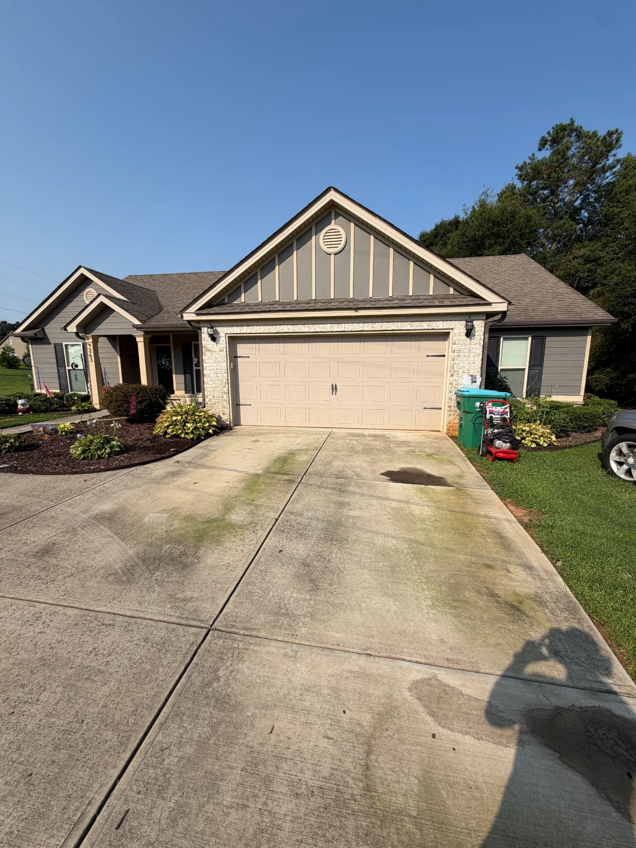 Concrete driveway and front walkway leading to a residential home